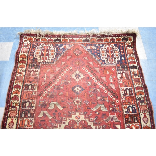 541 - A Vintage Patterned Woollen Rug on Red Ground, 257x160cm