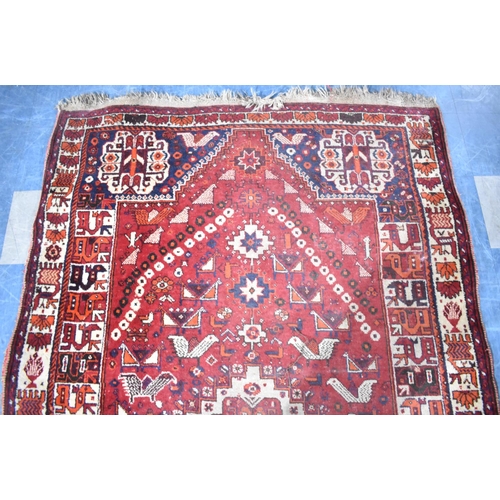 541 - A Vintage Patterned Woollen Rug on Red Ground, 257x160cm