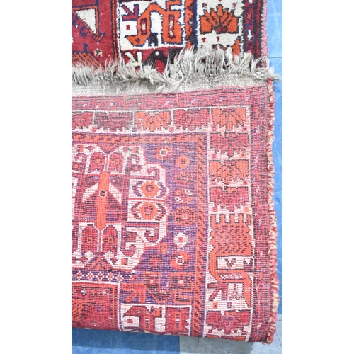 541 - A Vintage Patterned Woollen Rug on Red Ground, 257x160cm