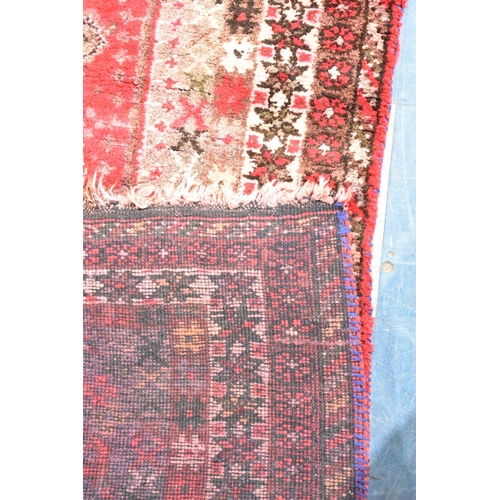 545 - A Patterned Rug on Red Ground, 190x154cm