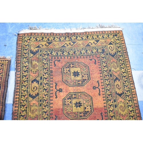 555 - Two Matching Patterned Rugs on Blue Ground, the Larger 220x113cm and Smaller 150x102cm