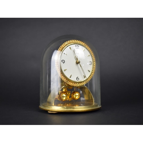 111 - A 1950s Kundo Pillar Clock under Glass Dome with Instructions and Key, 15cms High