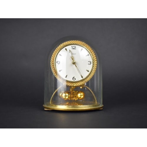 111 - A 1950s Kundo Pillar Clock under Glass Dome with Instructions and Key, 15cms High