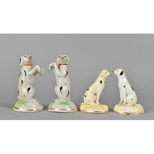 384 - A Pair of Ceramic Studies of Spotted Dogs, Modelled on Hind Legs, 9cm high Together with a Further P... 