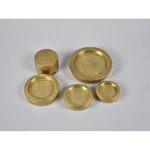 40 - A Graduated Set of Four Brass Bank Sovereign Coin Weights and a Circular Weight for £5 Silver