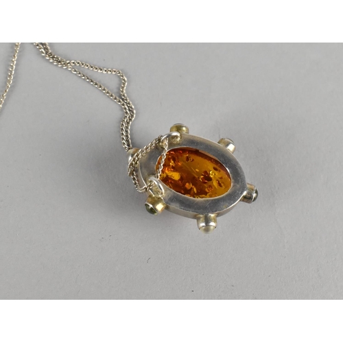 426 - A Silver Mounted Pendant with Amber Cabochon Set Along with Three Small Peridot and Three Moonstone ... 