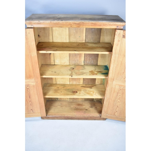 534 - A Late 19th/Early 20th Century Stripped Pine Cabinet with Panelled Doors to Shelved Interior, 96cms ... 