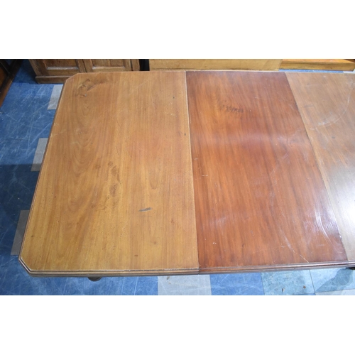 539 - An Edwardian Mahogany Wind Out Rectangular Dining Table with Turned Supports and One Extra Leaf Exte... 