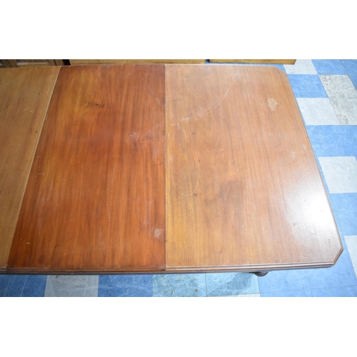 539 - An Edwardian Mahogany Wind Out Rectangular Dining Table with Turned Supports and One Extra Leaf Exte... 