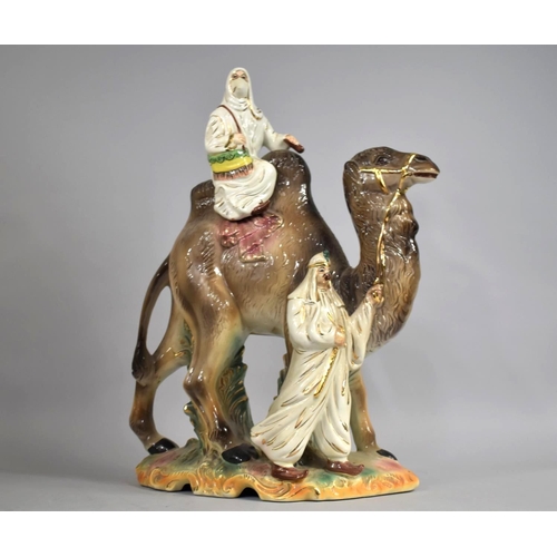 77 - A Large Mid 20th Century Glazed Ceramic Figure Group, Arabic Woman Riding Camel with Gent Leading, 5... 