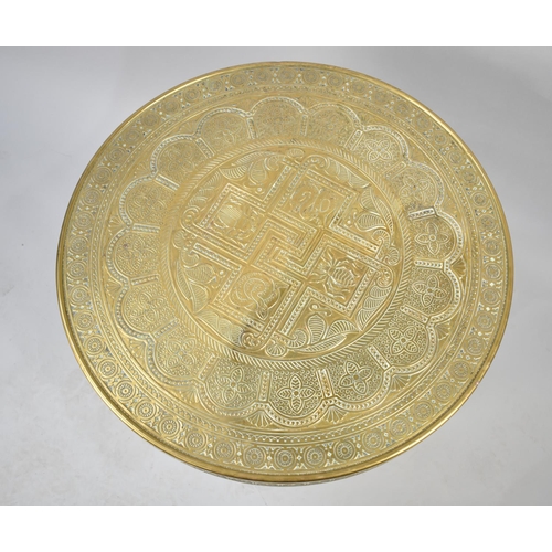 85 - An Indian Brass Benaries Tray Top on Folding Wooden Stand, 60cms Diameter