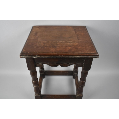 9 - An Oak Rectangular Topped Stool with Turned Supports, 30x26cms