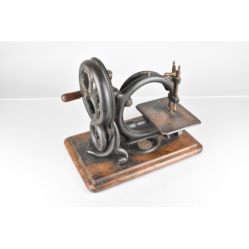 96 - A Late 19th Century Willcox and Gibbs Sewing Machine Co, Hand Cranked Sewing Machine On Wooden Plint... 