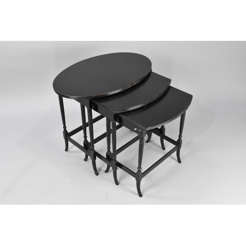 25 - A 19th Century Nest of Three Ebonised Tables With Oval Tops Over Turned Legs United By Stretchers, W... 