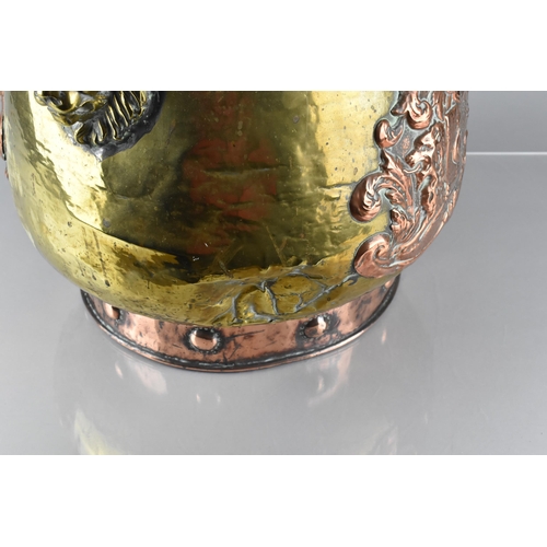 197 - A Brass and Copper Log Bin/Coal Bucket with Heraldic Crest ad Lion Mask Handles, 33.5cms High