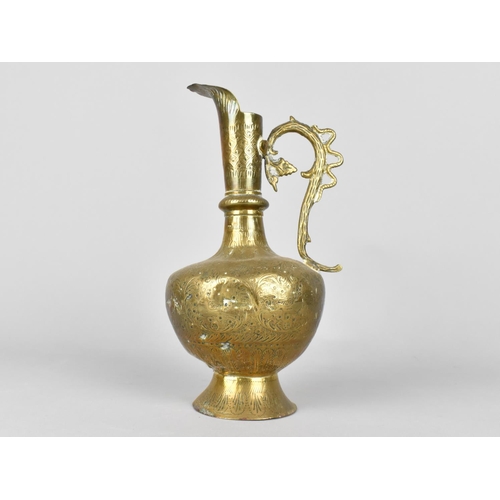 130 - An Indian Brass Jug with Finely Engraved Foliate Decoration. 22cms High