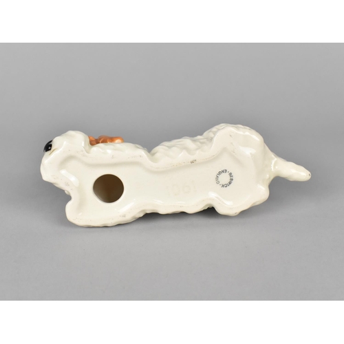 412 - A Beswick Model of a Recumbent Terrier, no. 1061