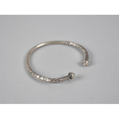 460 - An Ethnic White Metal Bangle, Hammered Decoration and Cone Finials, 21.5gms