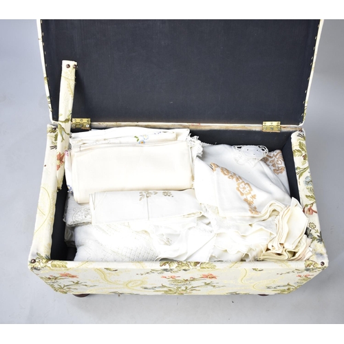 562 - A Mid 20th Century Upholstered Blanket Chest Containing a Large Quantity of Table Linens, Fabrics et... 