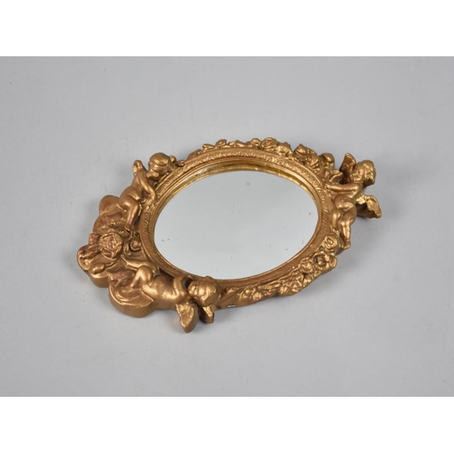 93 - A Modern Moulded Gilt Framed Oval Wall hanging Mirror with Cherub Finial, 23cms High