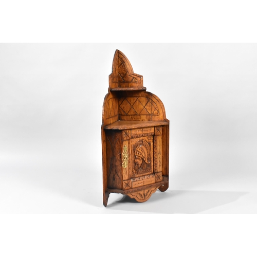 402 - A Small Edwardian Carved Oak Wall Hanging Corner Cabinet with Warrior Mask Decoration to Panelled Cu... 