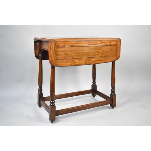 105 - A Mid/Late 20th Century Oak Drop Leaf Trolley, Turned Supports but Missing Castors, 68cms Wide