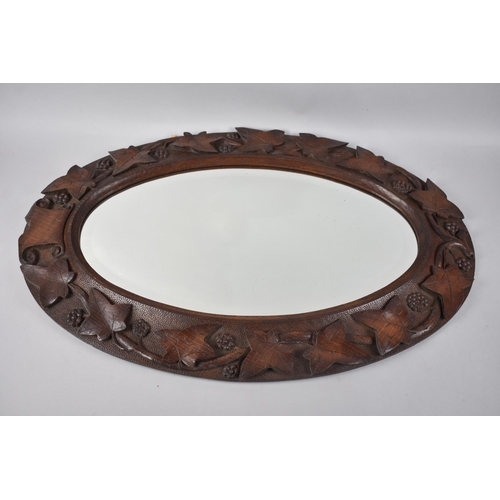 246 - A Nice Quality Carved Oak Framed Oval Wall Mirror Decorated in High Relief with Vine Leaf and Grapes... 