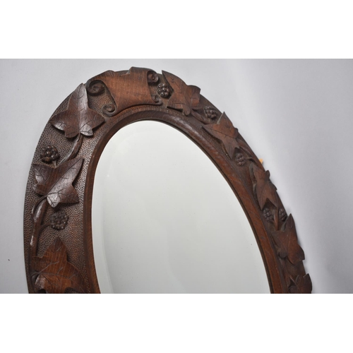 246 - A Nice Quality Carved Oak Framed Oval Wall Mirror Decorated in High Relief with Vine Leaf and Grapes... 