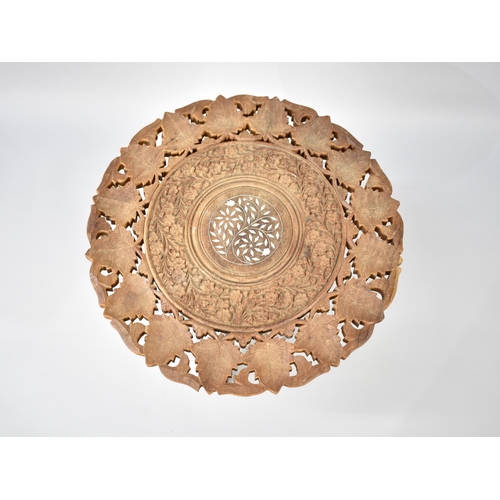 249 - A Far Eastern Carved and Pierced Circular Table on Folding Tripod Stand, 45cms Diameter