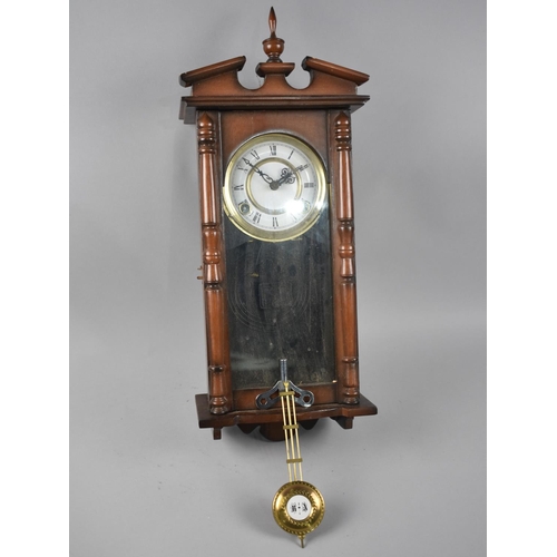 322 - A Mahogany Cased Vienna Style Wall Clock, with Key and Pendulum