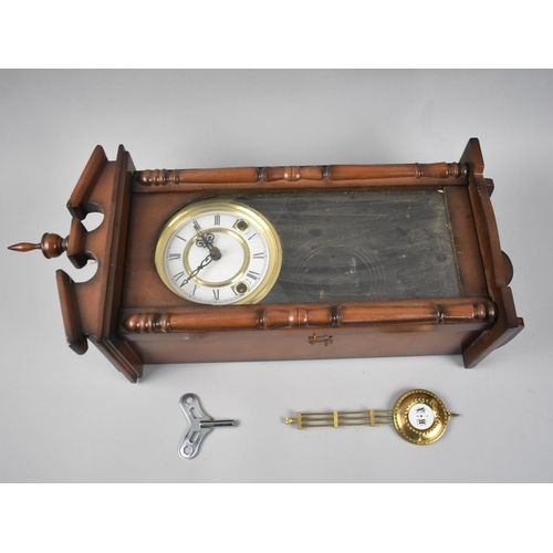 322 - A Mahogany Cased Vienna Style Wall Clock, with Key and Pendulum