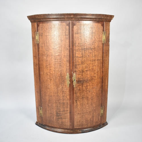 555 - A 19th Century Bow Fronted Wall Hanging Oak Corner Cupboard, 78cms Wide and 108cms High