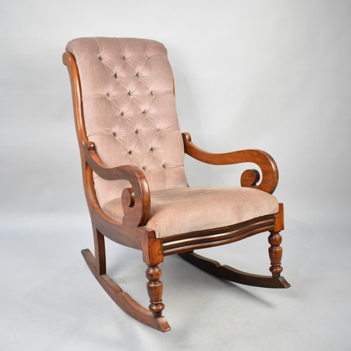 560 - A Reupholstered Mahogany Framed Victorian Rocking Chair with Button Back and Scrolled Arms