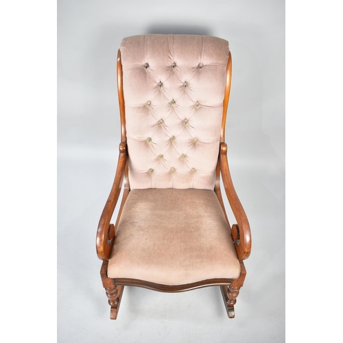 560 - A Reupholstered Mahogany Framed Victorian Rocking Chair with Button Back and Scrolled Arms