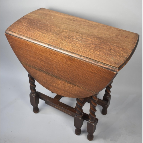 79 - A Mid 20th Century Oak Barley Twist Drop Leaf Gate Leg Table with Oval Top, 73cms Wide