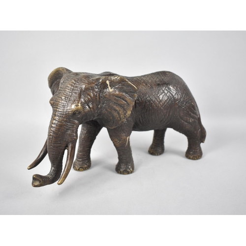 82 - A Large Heavy Patinated Bronze Study of an Elephant, 30cms Long