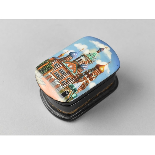 12 - A Small Souvenir Russian Enamelled Box with Hinged Lid Decorated with the Kremlin, 5.5cm Long