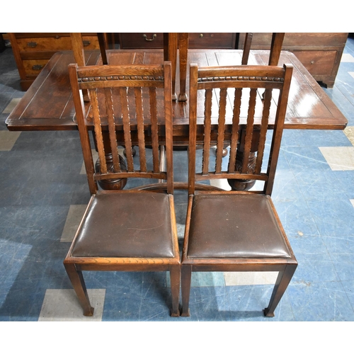 575 - An Edwardian Oak Draw Leaf Extending Dining Table on Carved Bulbous Supports Together with Four Oak ... 