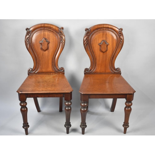 84 - A Pair of Victorian Mahogany Hall Chairs with Shield Moulded Backs