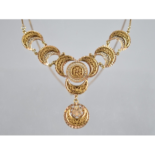 61 - A Two Tone Gold Metal Filigree Necklace Comprising Crescents Raised on Textured Plaques, Each 16mm W... 