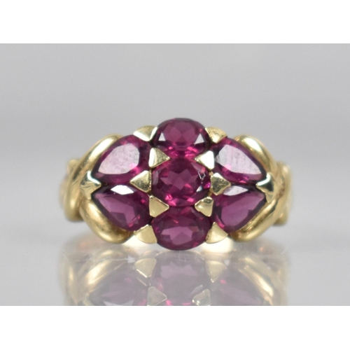 82 - A 9ct Gold and Garnet Cluster Dress Ring Comprising Oval and Pear Cut Garnets, Tension/Pave Set in L... 