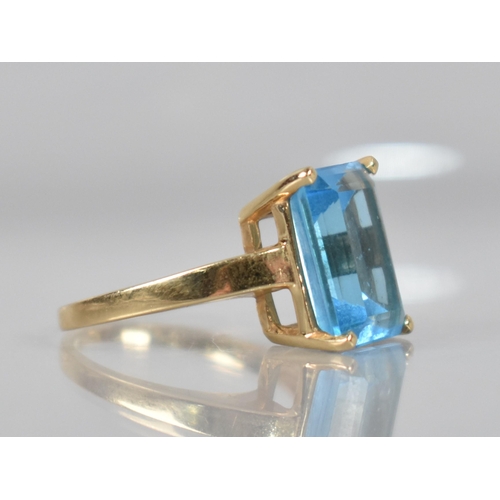 83 - A 14ct Gold Mounted Blue Stone Ring, Testing as Sapphire, Emerald Cut Measuring 13.9mm by 9.7mm and ... 