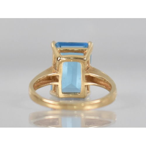 83 - A 14ct Gold Mounted Blue Stone Ring, Testing as Sapphire, Emerald Cut Measuring 13.9mm by 9.7mm and ... 