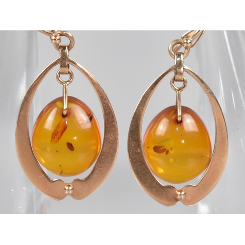 84 - A Pair of Russian 14ct Rose Gold and Amber Earrings, Ovoid Amber Drops Measuring 12.9mm by 14.5mm an... 