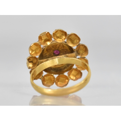 85 - An Indian Gold Coloured Metal and Ruby Ring, Central Ruby Measuring 3.6mm by 3.0mm in a Raised Crimp... 