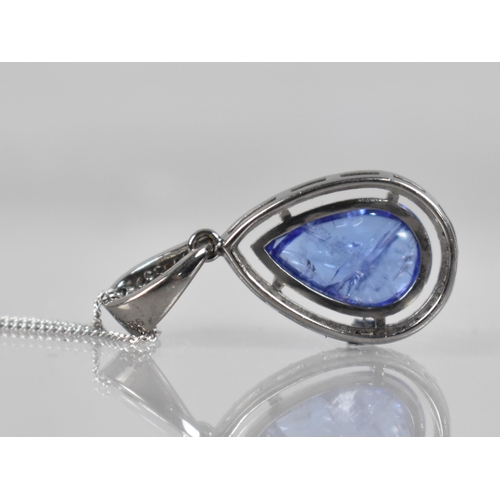 111 - A Tanzanite and Diamond Set Pendant, Central Pear Shaped Cabochon Tanzanite Measuring Approx 4.90ct,... 