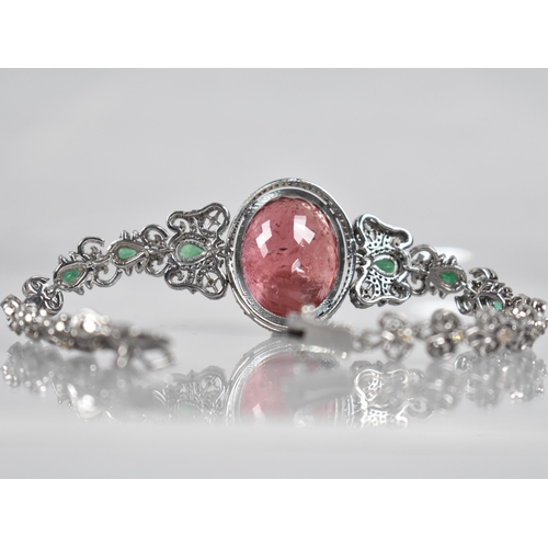 117 - A Rubellite, Emerald and Diamond Bracelet. Large Oval Cut Rubellite Stone Measuring 26.42cts, 22.9mm... 