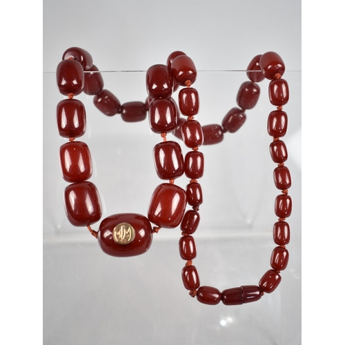 232 - A String of 41 Cherry Bakelite 'Amber' Beads, Largest Measuring 29mm by 23.4mm with Yellow and White... 