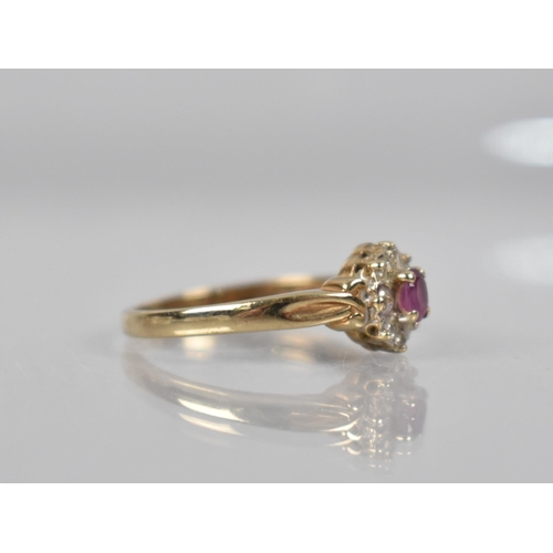 88 - A 9ct Gold, Diamond and Ruby Cluster Ring, Oval Cut Ruby Measuring 3.9mm by 2.8mm Set in Four Claws ... 