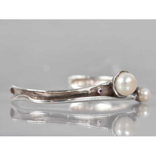 213 - A Modernist Silver Cuff having Pearl and Ruby Embellishments, Collet Mounted Stones to a Folded Orga... 